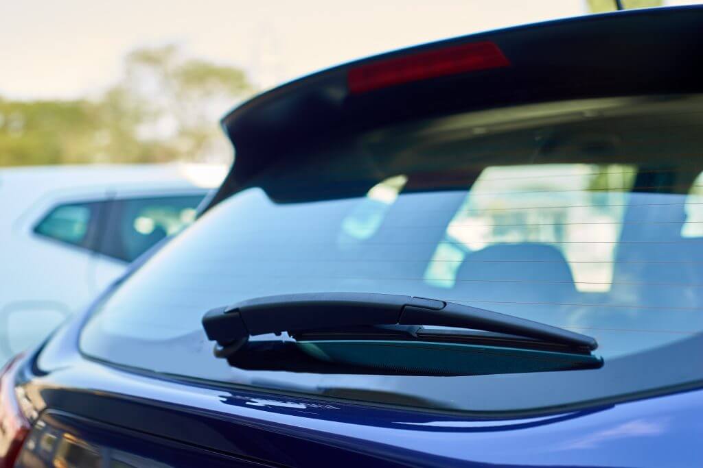 A car with a window and a hood, showcasing the glass on the window and the sleek design of the car.