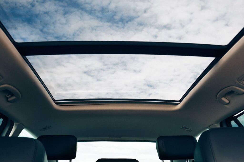 The open sunroof enhances the driving experience with fresh air and sunlight