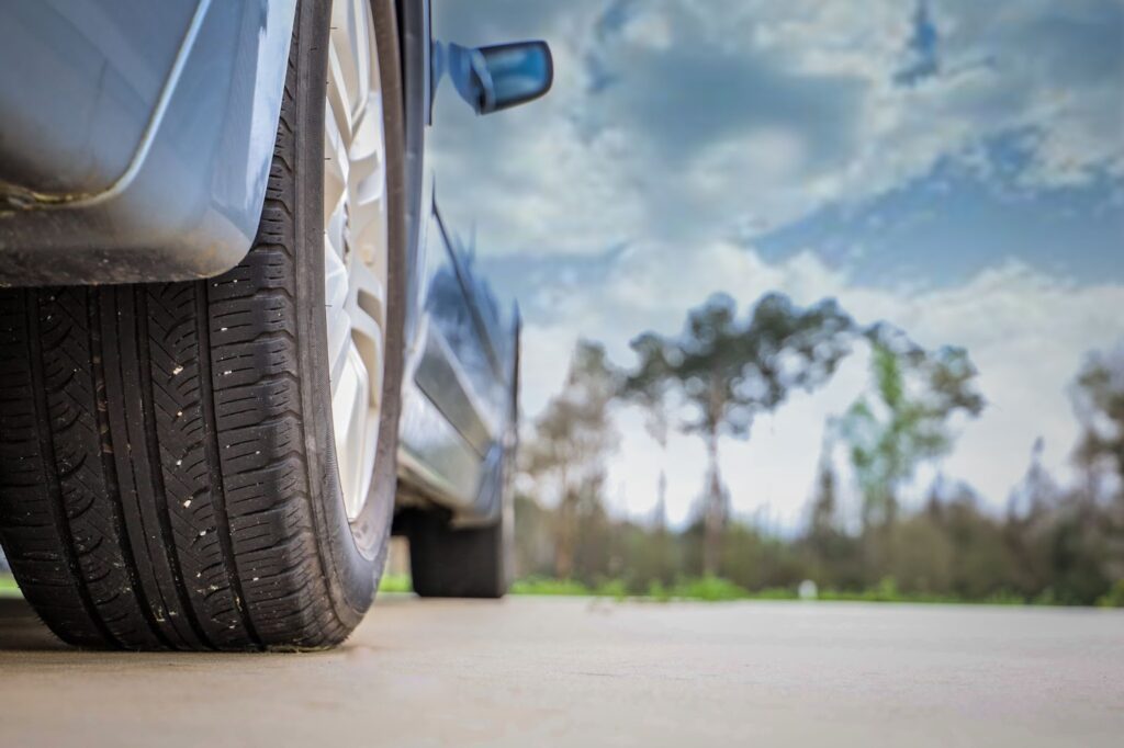 Close-up of a car tire on the ground, crucial for road trip and car maintenance checklist
