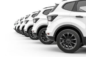 A row of white SUVs on a white background.