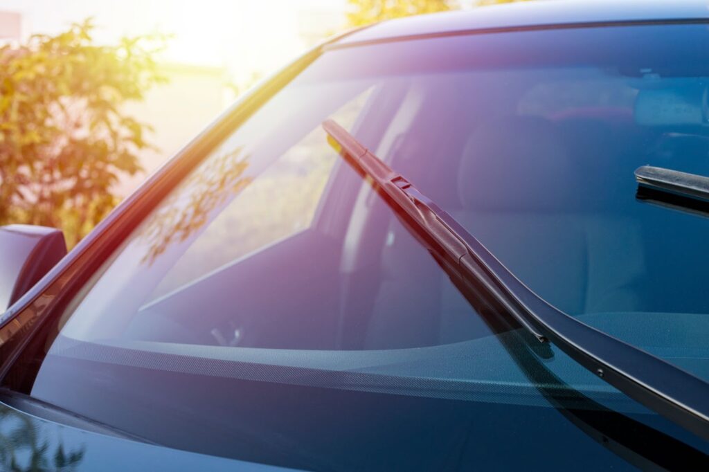 A car windshield featuring a pair of wipers, highlighting the importance of windshield maintenance in Utah.