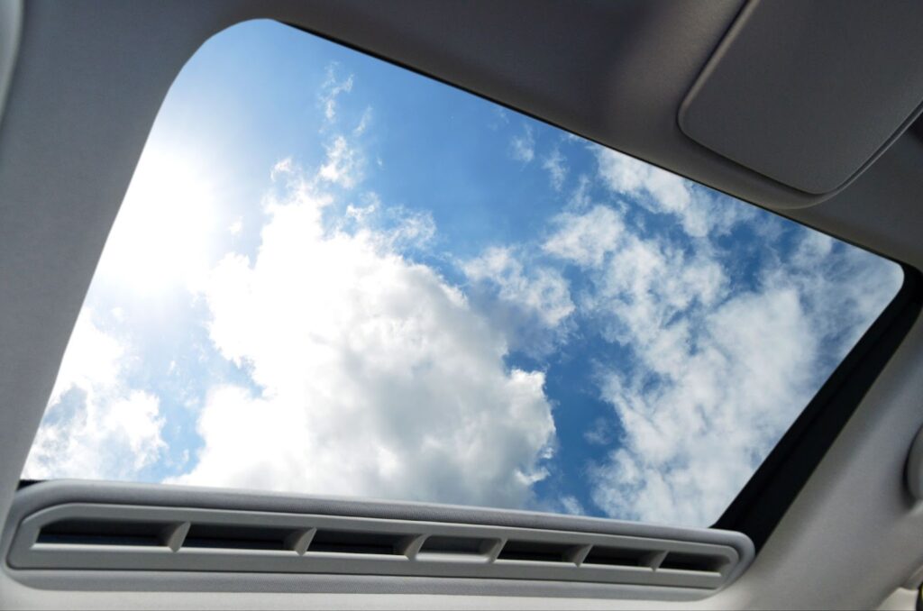 A close-up view of a car,s sunroof, highlighting the glass panel and its potential replacement costs.