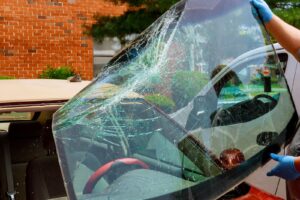 A technician repairs a fleet vehicle,s windshield in Salt Lake City,ensuring safety and visibility for drivers.