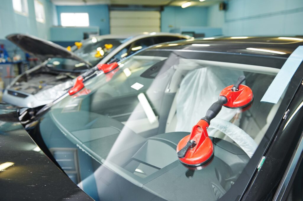 Replacement windshield installation with professional auto glass tools